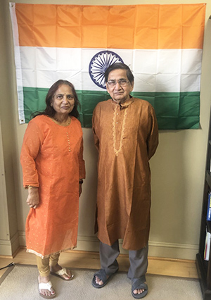 Couple standing in front of flag.